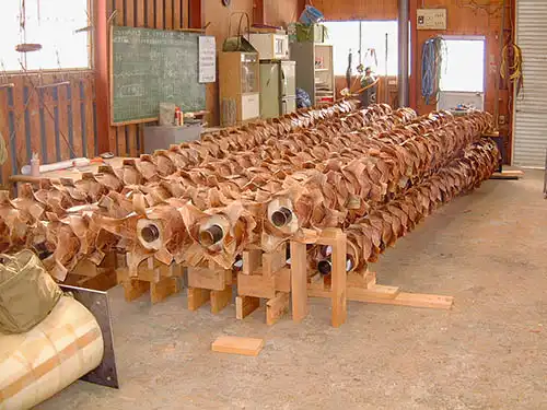 人工樹木ヤシの木に、一枚ずつ樹皮を貼り付けている様子